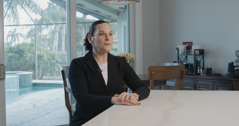 photo of tgh concierge health patient kim hoffmanat her kitchen table with enclosed pool in background