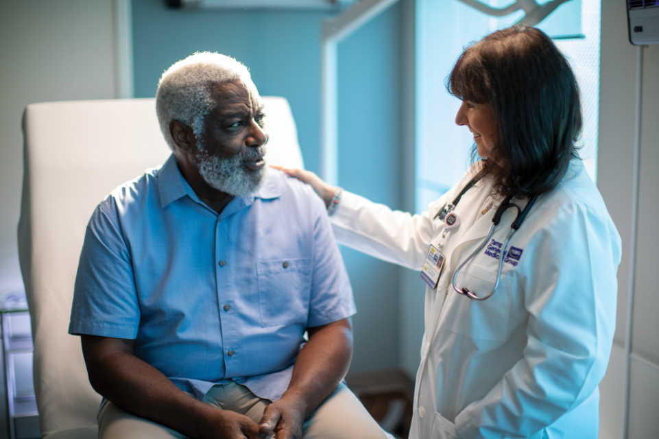 tgmg physician dr debbie rinde-hoffman consoles a male patient in her pasco county ofice