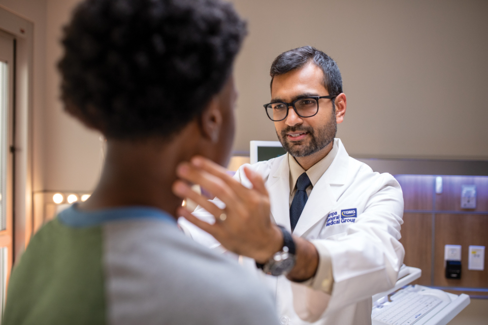 tgmg physician dr nishit patel examines a male patient in his pinellas county office